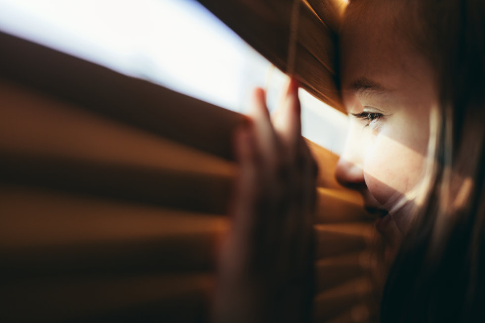 young-girl-looking-through-blind - police surveillance - privacywe